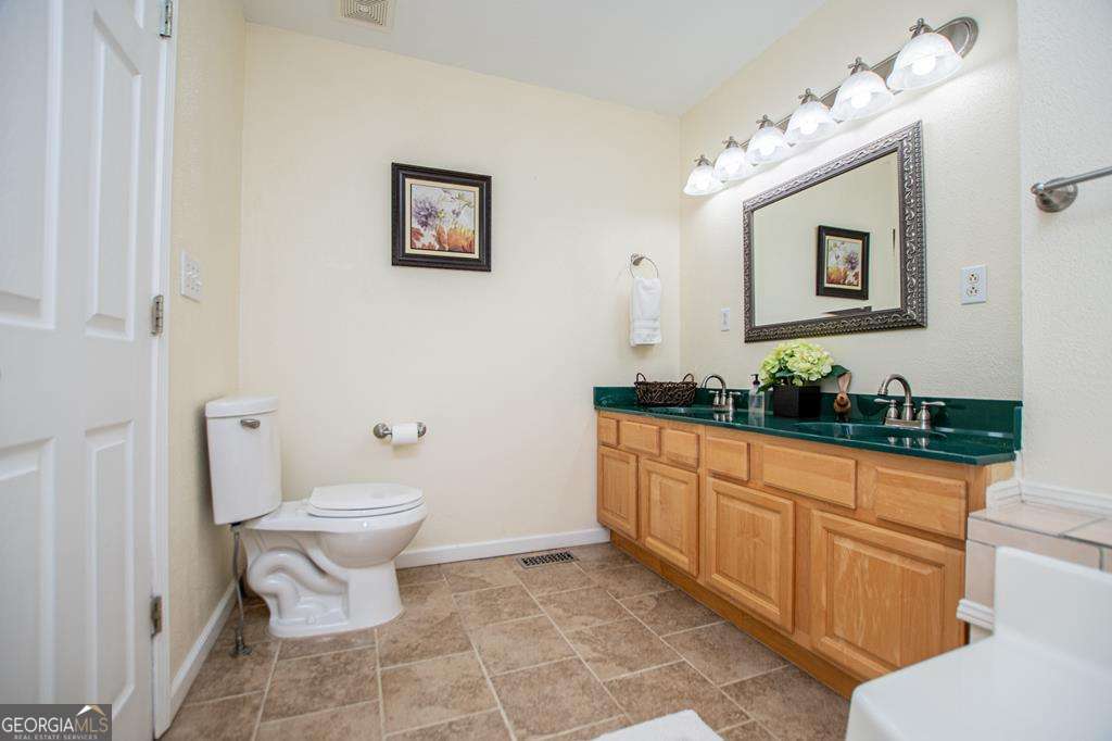 2 Pine Hill Drive Ranburne, AL 36273 - Photo 43 of 91 a bathroom with a toilet sink and mirror