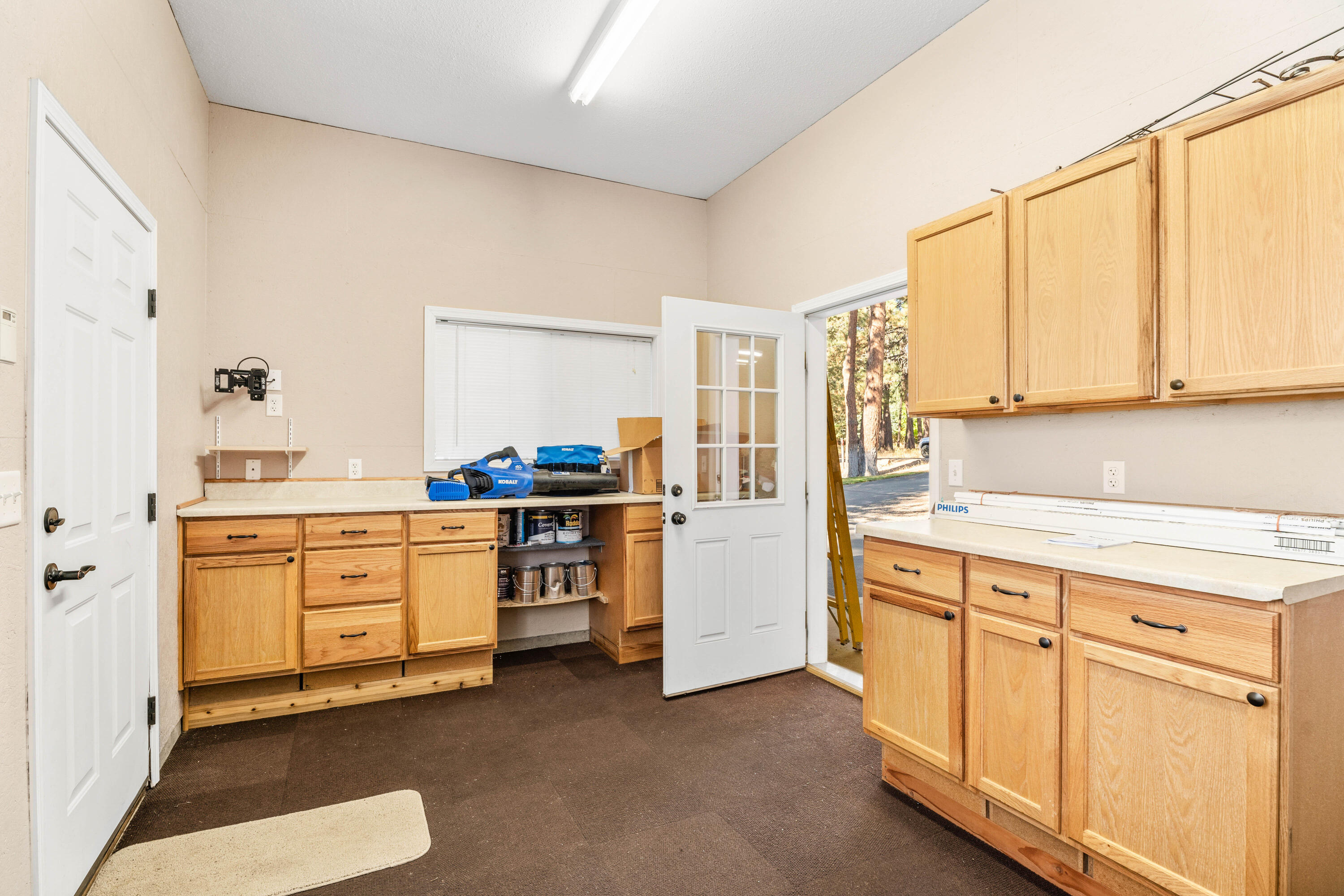 19031 Baker Road Bend, OR 97702 - Photo 23 of 35 a kitchen with granite countertop white cabinets and white appliances