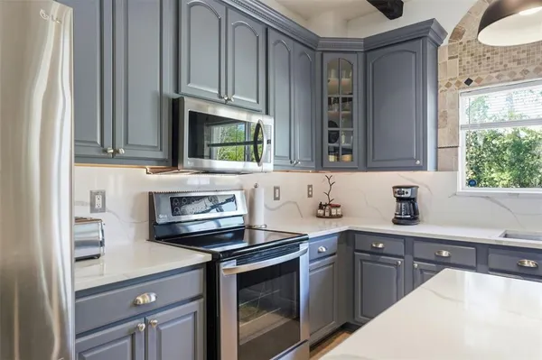a living room with furniture a flat screen tv and a large window