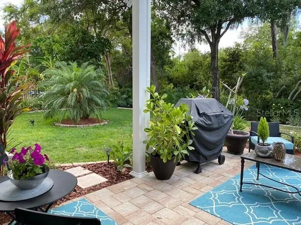 a bedroom with a bed a couch and a flat screen tv