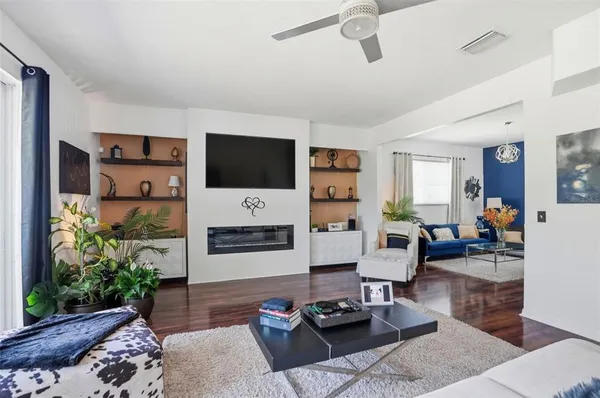a spacious bedroom with a bed and a chandelier