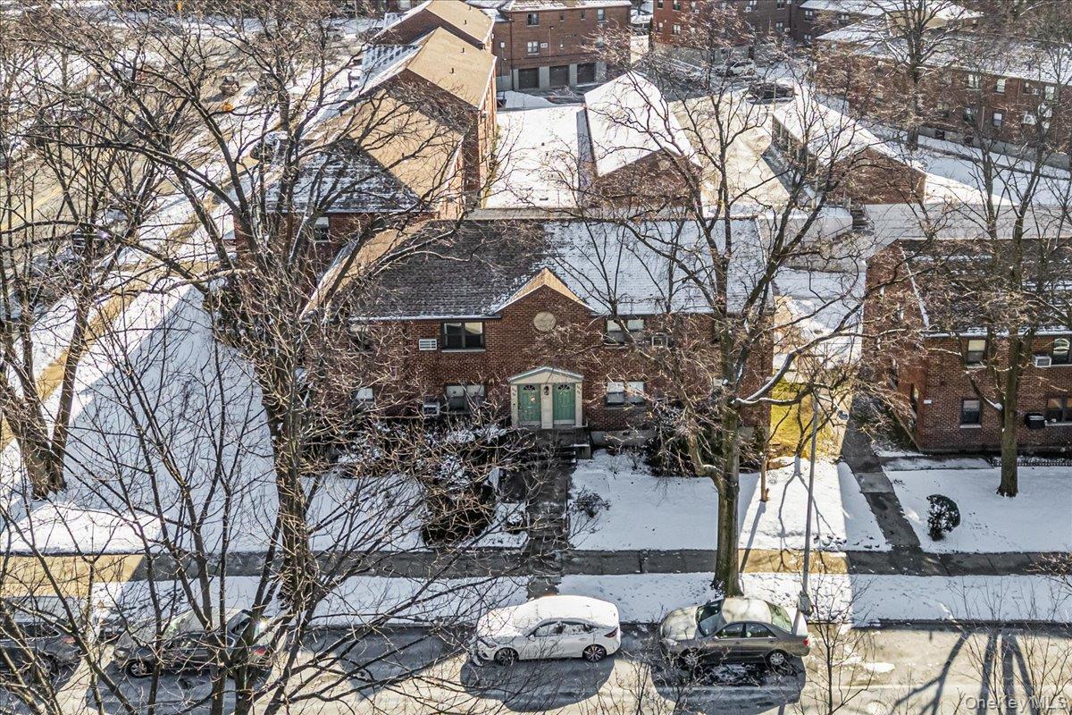 242-68 Horace Harding Expressway, Unit UPPR Queens, NY 11362 - Photo 2 of 11 a front view of a house with a yard and garage
