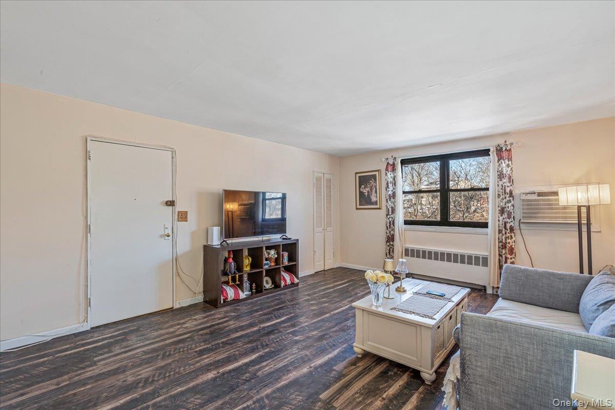 242-68 Horace Harding Expressway, Unit UPPR Queens, NY 11362 - Photo 3 of 11 a living room with furniture and a flat screen tv