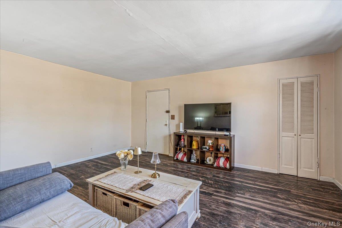242-68 Horace Harding Expressway, Unit UPPR Queens, NY 11362 - Photo 4 of 11 a living room with furniture and a flat screen tv