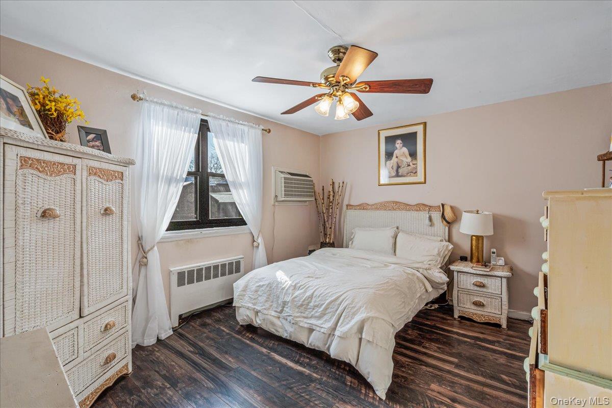 242-68 Horace Harding Expressway, Unit UPPR Queens, NY 11362 - Photo 8 of 11 a bedroom with a bed and a chandelier