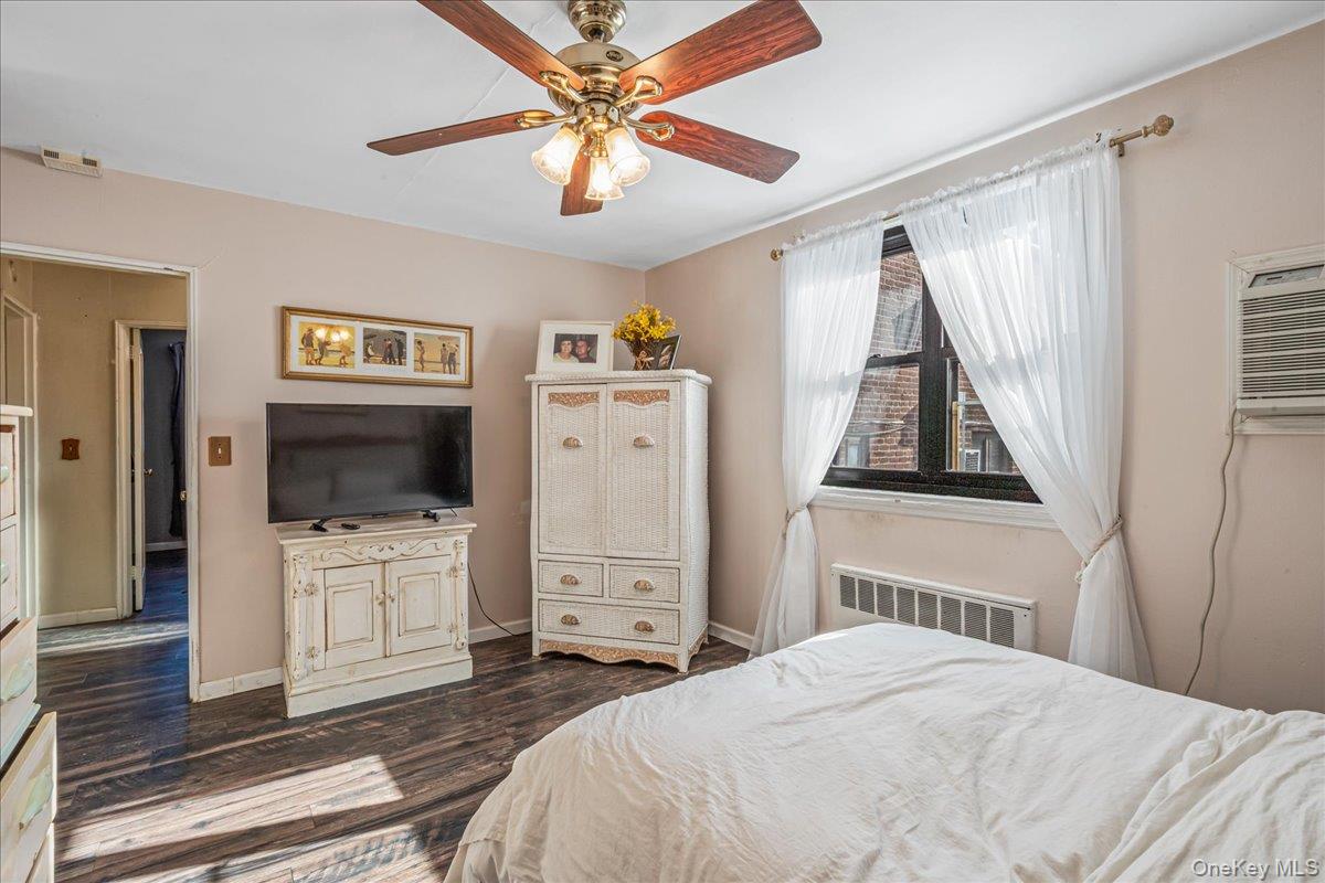 242-68 Horace Harding Expressway, Unit UPPR Queens, NY 11362 - Photo 9 of 11 a bedroom with a bed and a flat screen tv