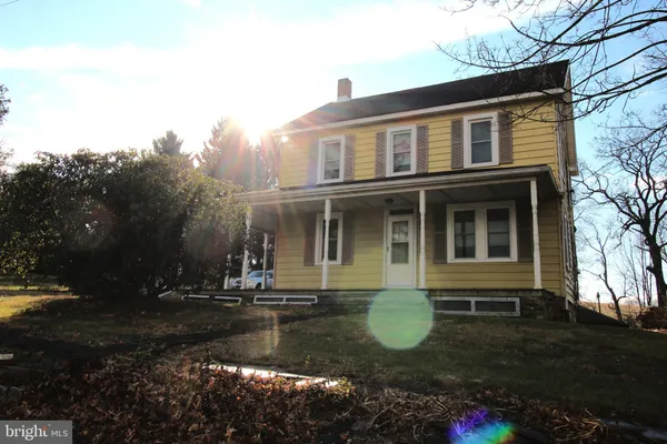 a front view of a house with yard and green space