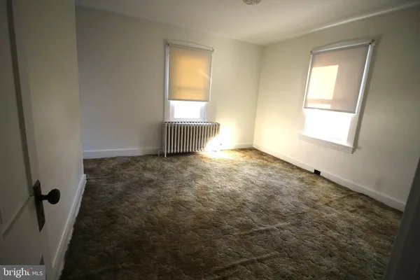 a view of an empty room and a window