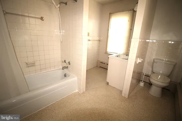 a bathroom with a tub and a shower