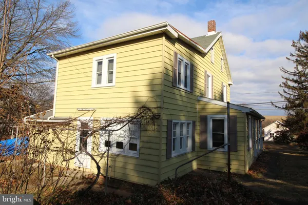 a view of a house with a yard and stairs