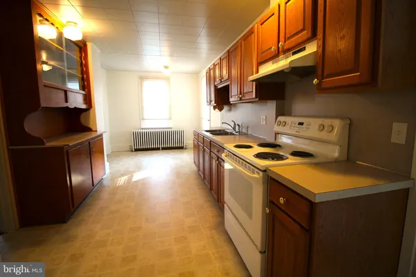 a kitchen with a sink a stove and a refrigerator