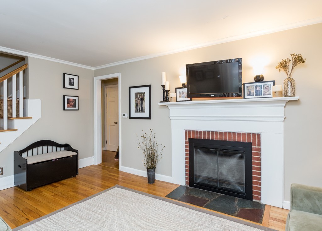 75 Pilgrim Road Springfield, MA 01118 - Photo 7 of 30 a living room with furniture a flat screen tv and a fireplace