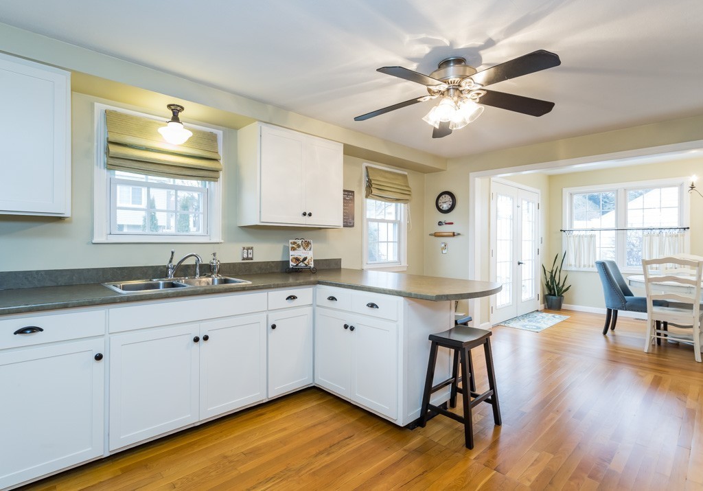 75 Pilgrim Road Springfield, MA 01118 - Photo 9 of 30 a kitchen with granite countertop a stove a sink and dishwasher with wooden floor