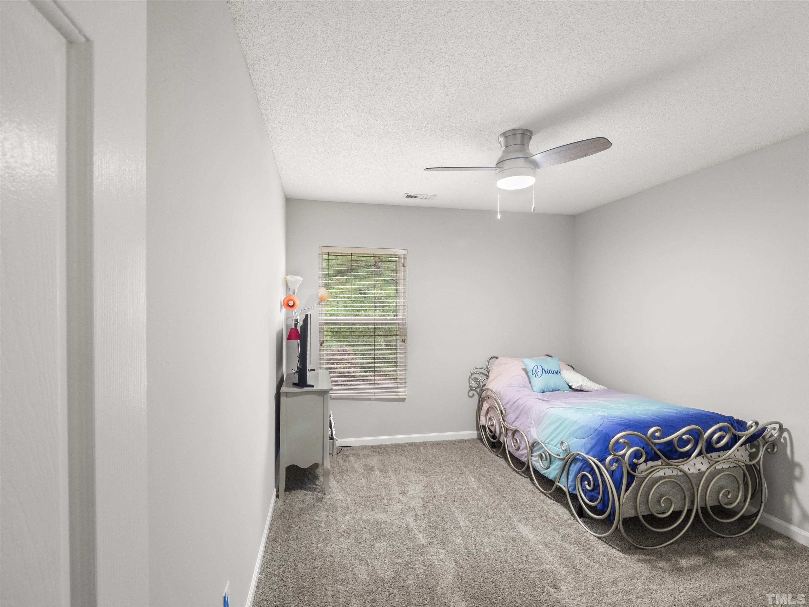 4 Red Spring Court Durham, NC 27703 - Photo 20 of 35 a bedroom with a bed and a window