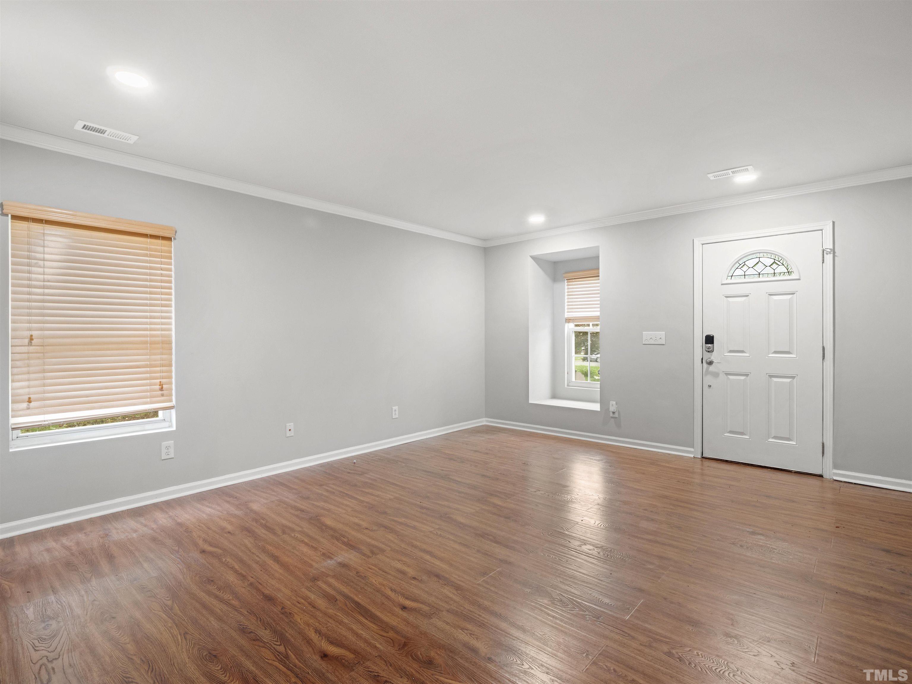 4 Red Spring Court Durham, NC 27703 - Photo 2 of 35 an empty room with wooden floor and windows