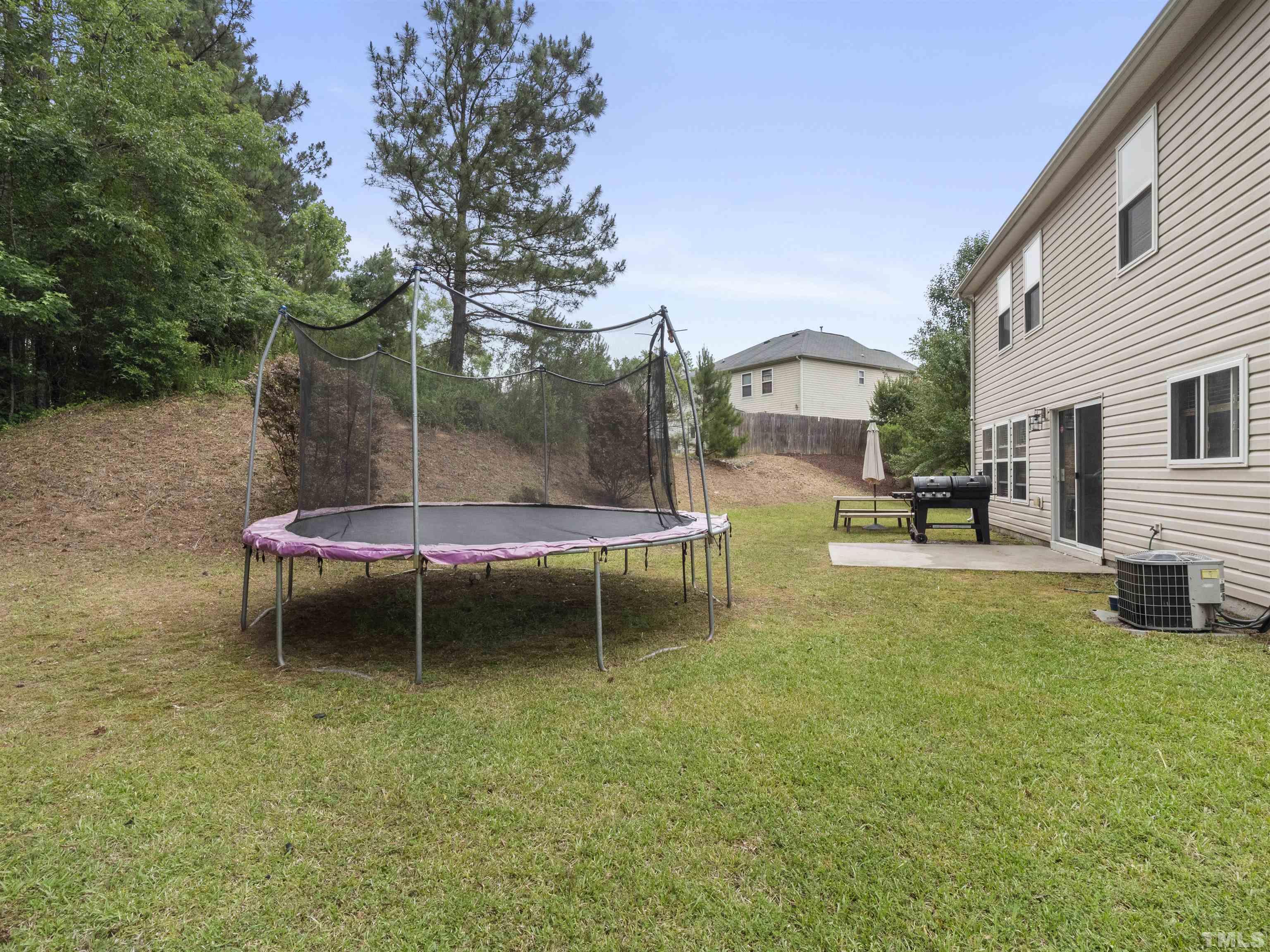 4 Red Spring Court Durham, NC 27703 - Photo 29 of 35 a backyard of a house with table and chairs