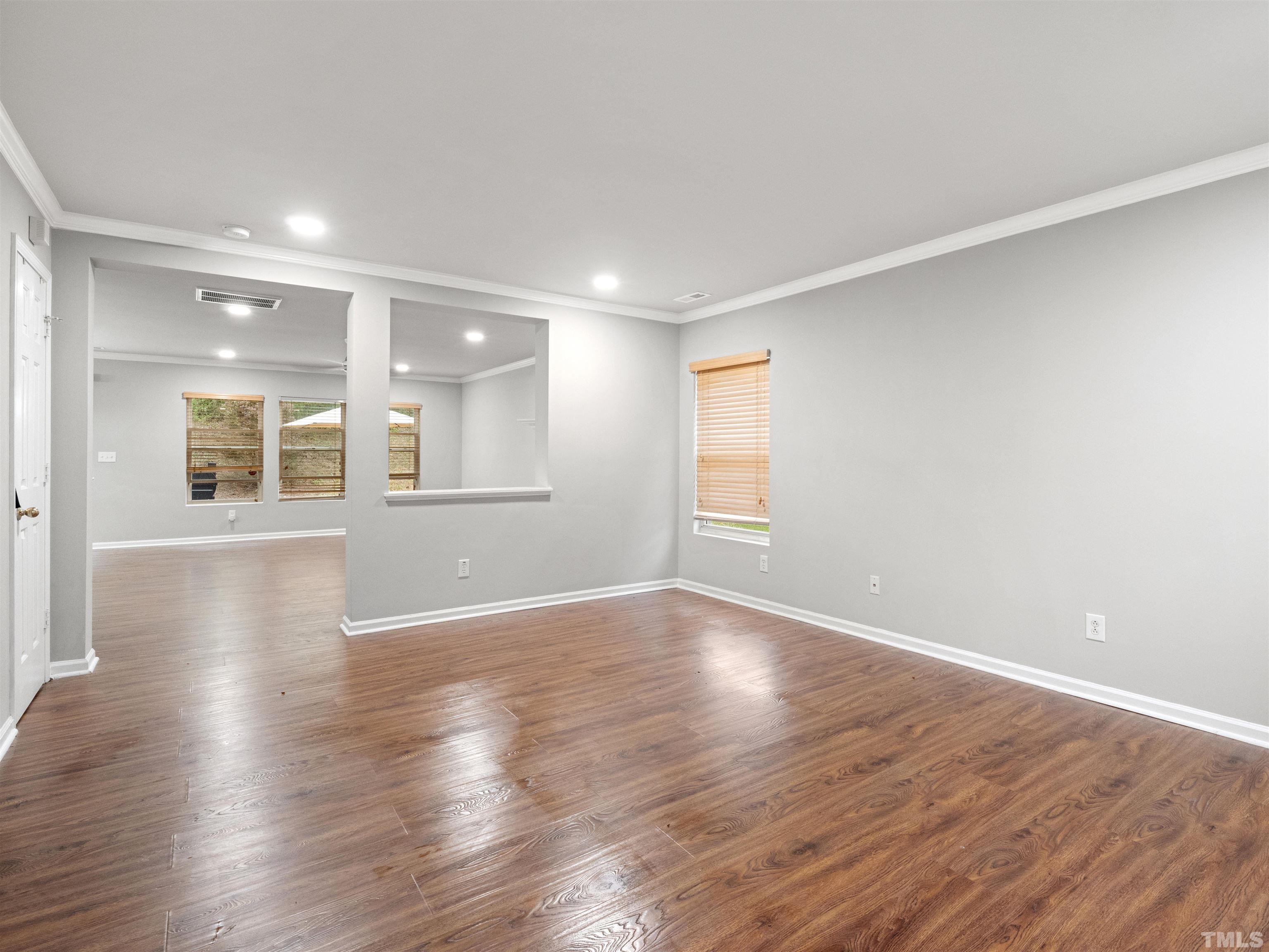 4 Red Spring Court Durham, NC 27703 - Photo 4 of 35 a view of an empty room with wooden floor and a window