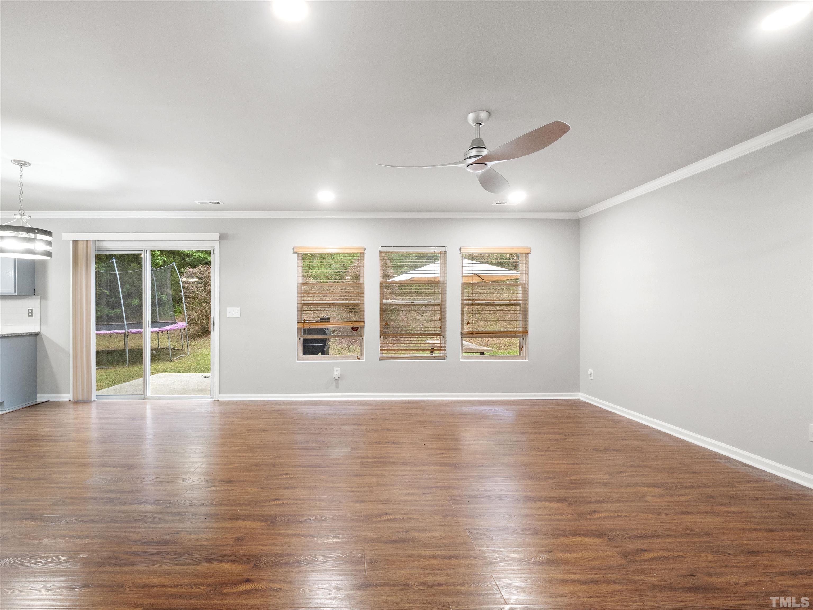 4 Red Spring Court Durham, NC 27703 - Photo 5 of 35 a view of an empty room with wooden floor and a window