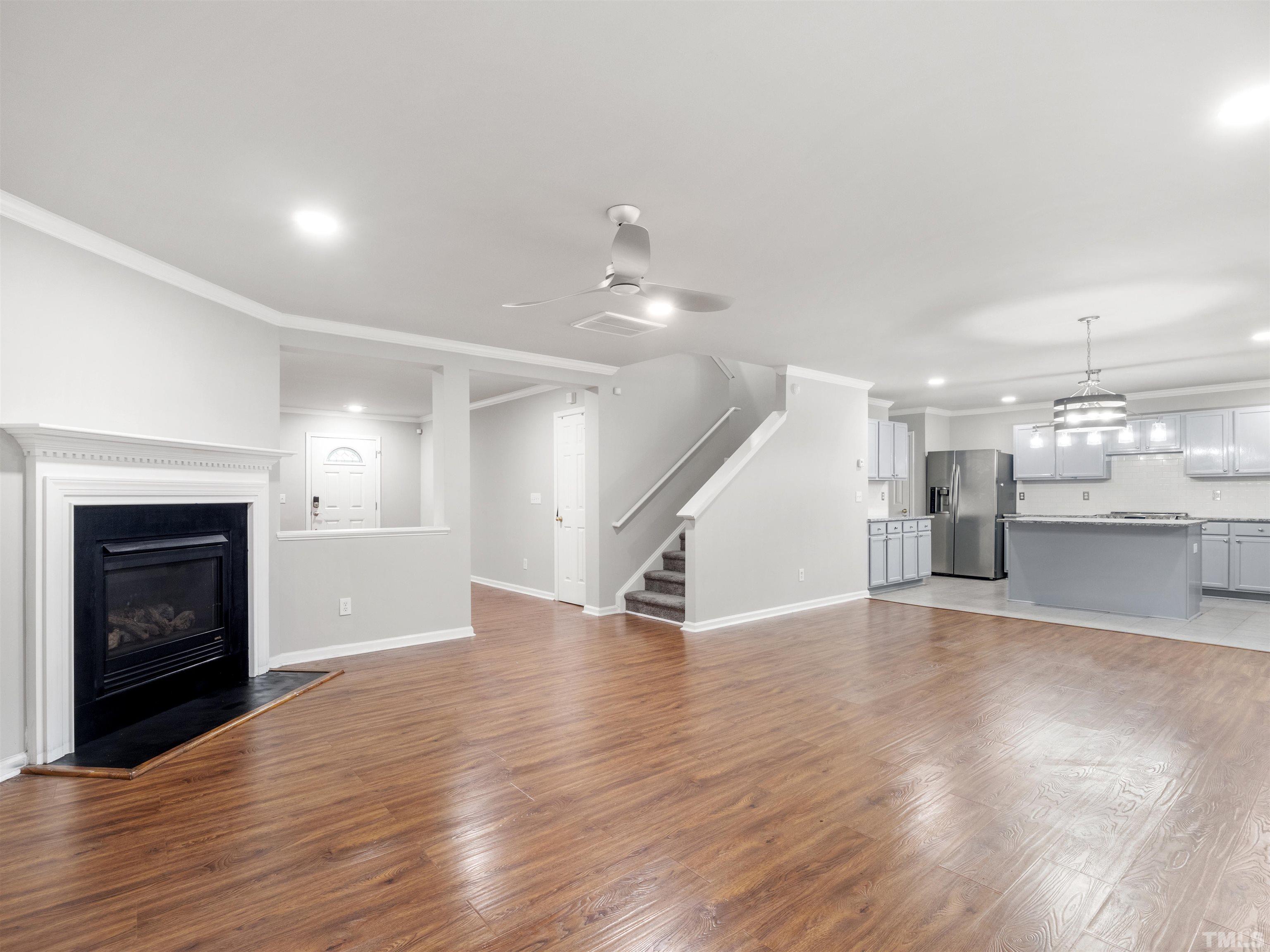 4 Red Spring Court Durham, NC 27703 - Photo 6 of 35 a view of an empty room with wooden floor fireplace and a window