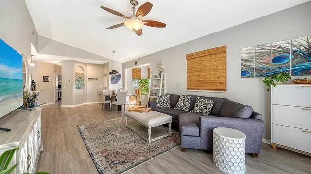 a living room with furniture and a wooden floor