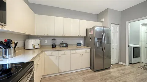 a kitchen with stainless steel appliances a refrigerator sink and cabinets