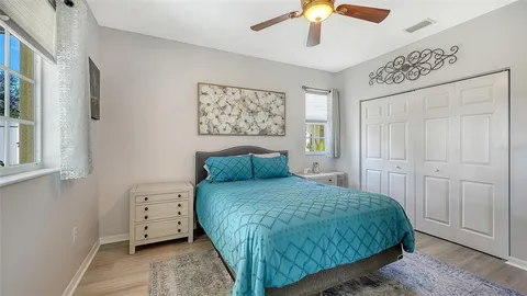 a bedroom with a bed and a chandelier