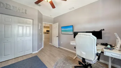 a bathroom with a granite countertop bathtub shower sink vanity and toilet