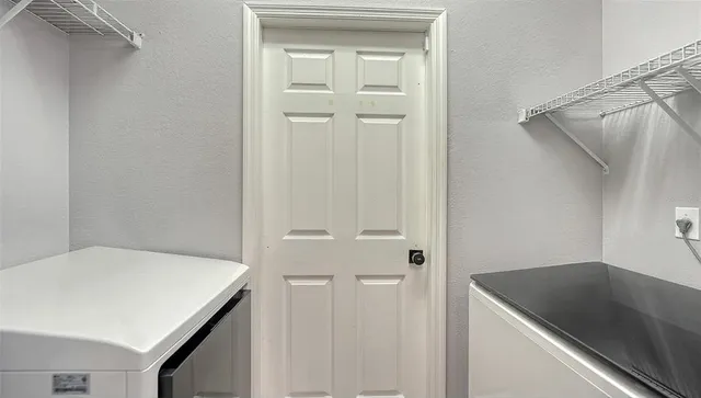 a vase of flowers sitting on a floor next to a yard