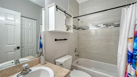 a bathroom with a toilet a sink and bathtub