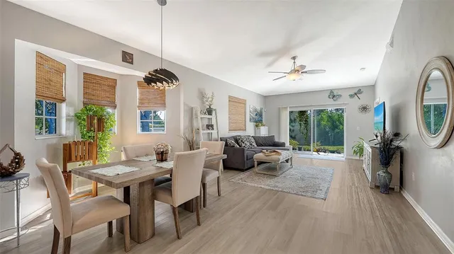 a living room with furniture a large window and a chandelier