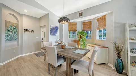 a view of a dining room with furniture window and wooden floor