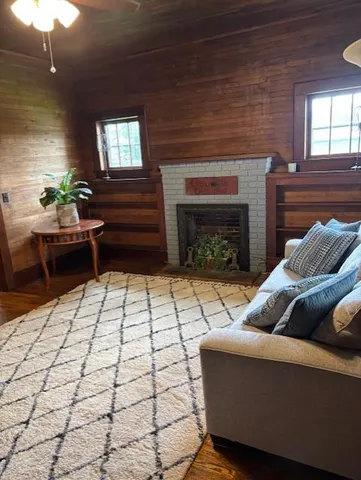 a living room with furniture and a fireplace