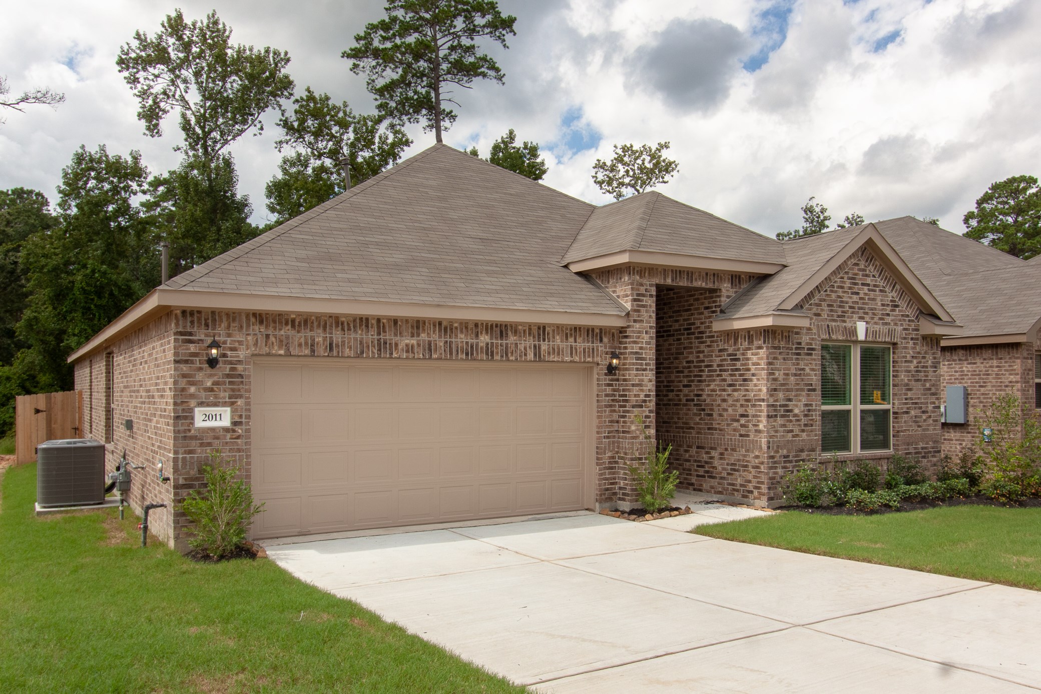 2011 Parnevik Place Conroe, TX 77304 - Photo 1 of 37 Beautiful brick home with Hardee plank trim and siding.