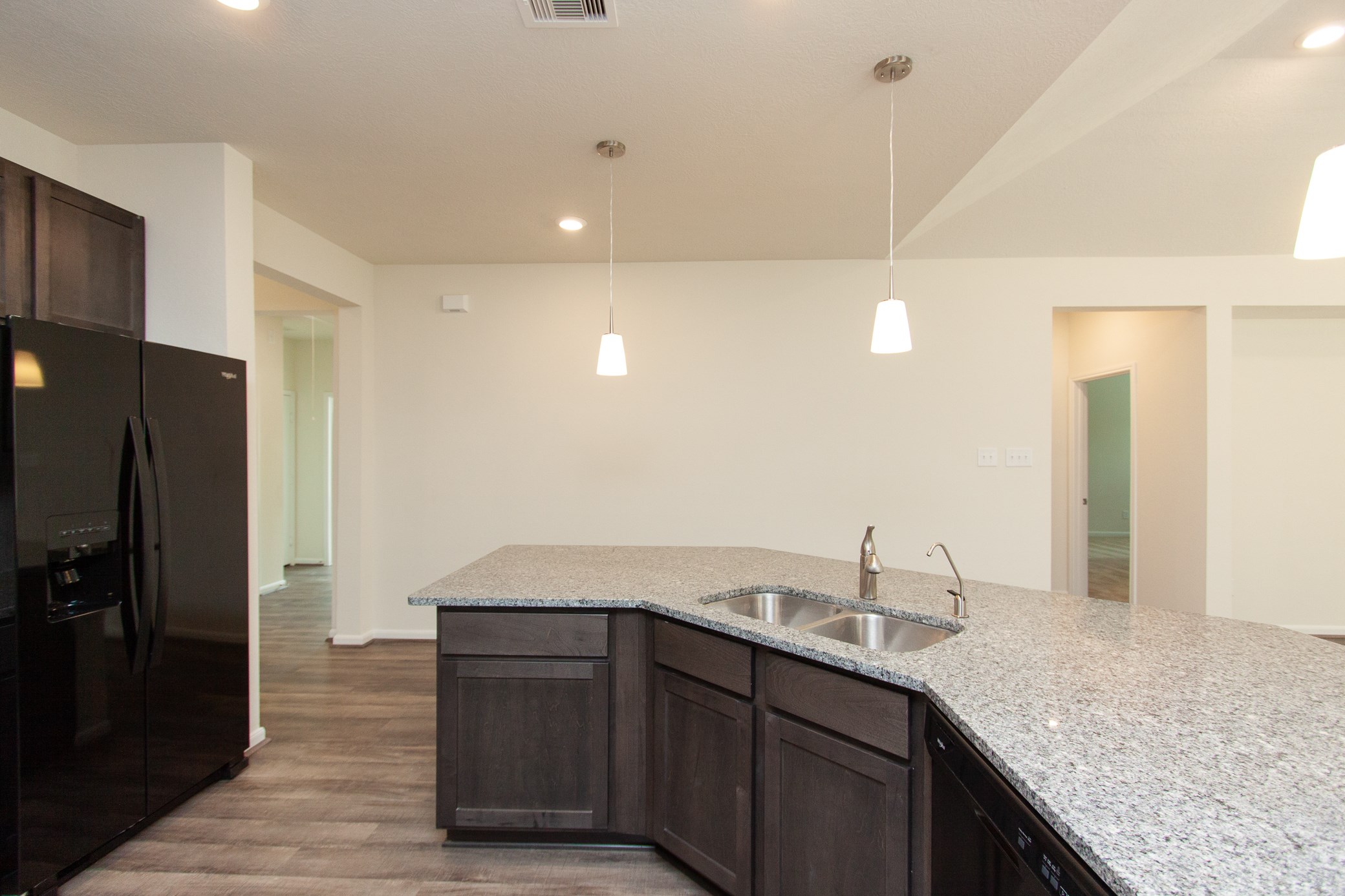 2011 Parnevik Place Conroe, TX 77304 - Photo 16 of 37 This is the view of the kitchen. It's 18X14. Beautiful pendalint lighting, bar top, breakfast bar.