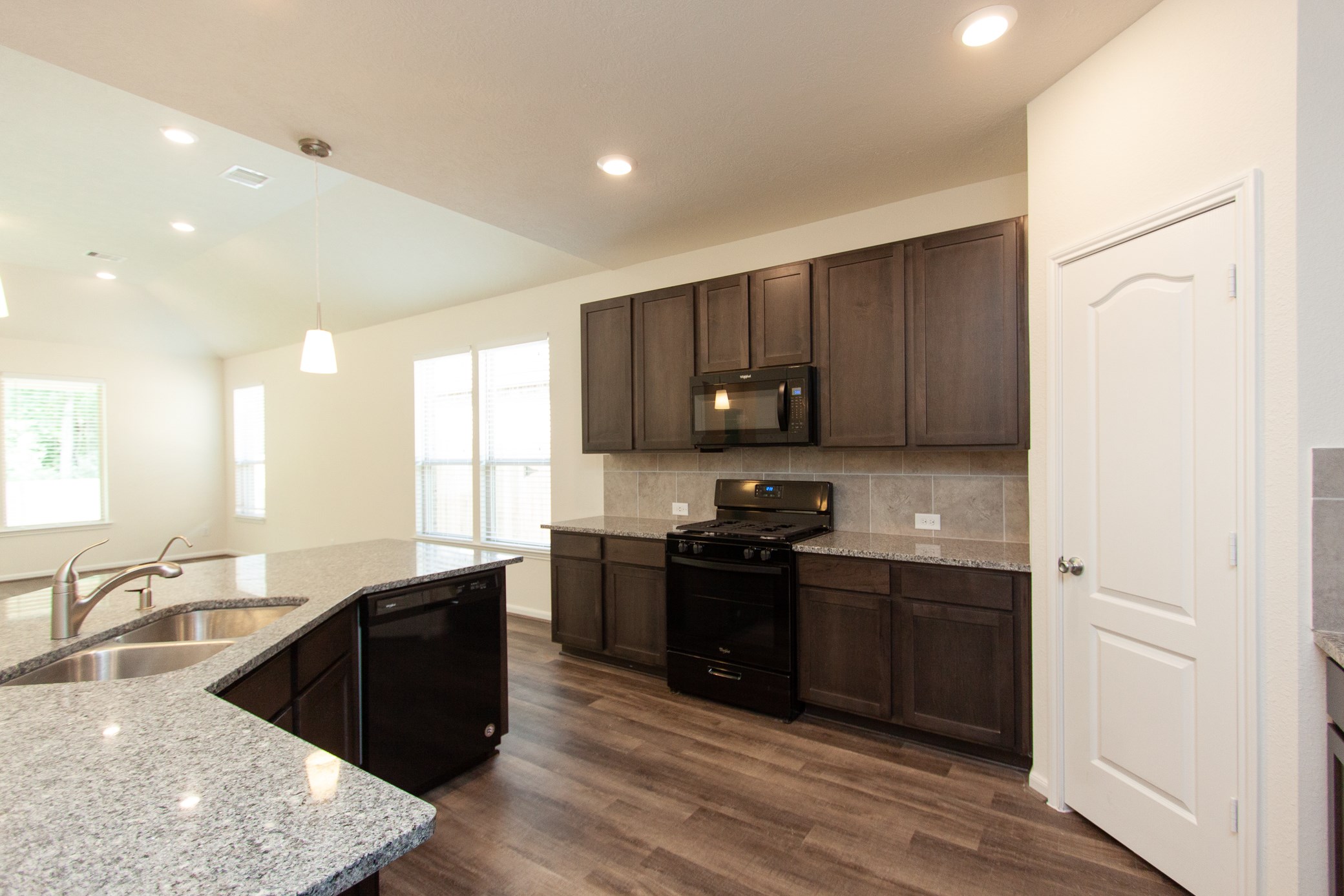 2011 Parnevik Place Conroe, TX 77304 - Photo 18 of 37 The oven has a 4 burner gas stove, dishwasher, microwave. The door to the right goes to the pantry, which is very spacious.