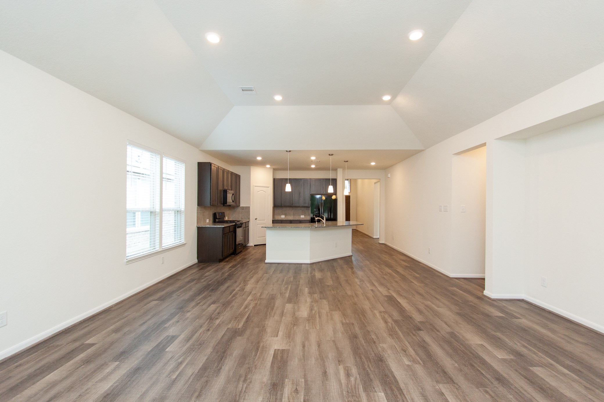 2011 Parnevik Place Conroe, TX 77304 - Photo 22 of 37 This photo shows the very high ceilings in this 23X20 living room with gorgeous laminent flooring.