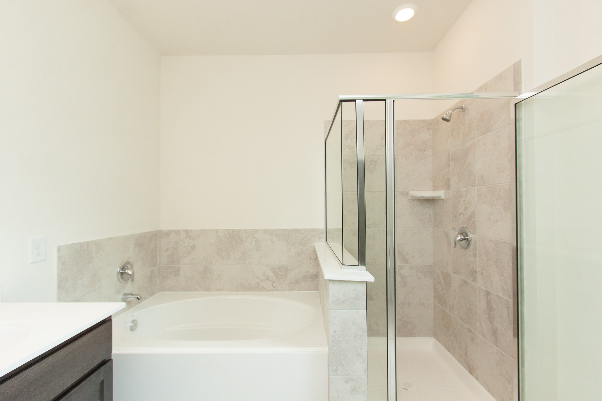 2011 Parnevik Place Conroe, TX 77304 - Photo 31 of 37 The Primary bathroom has a large garden tub and shower.