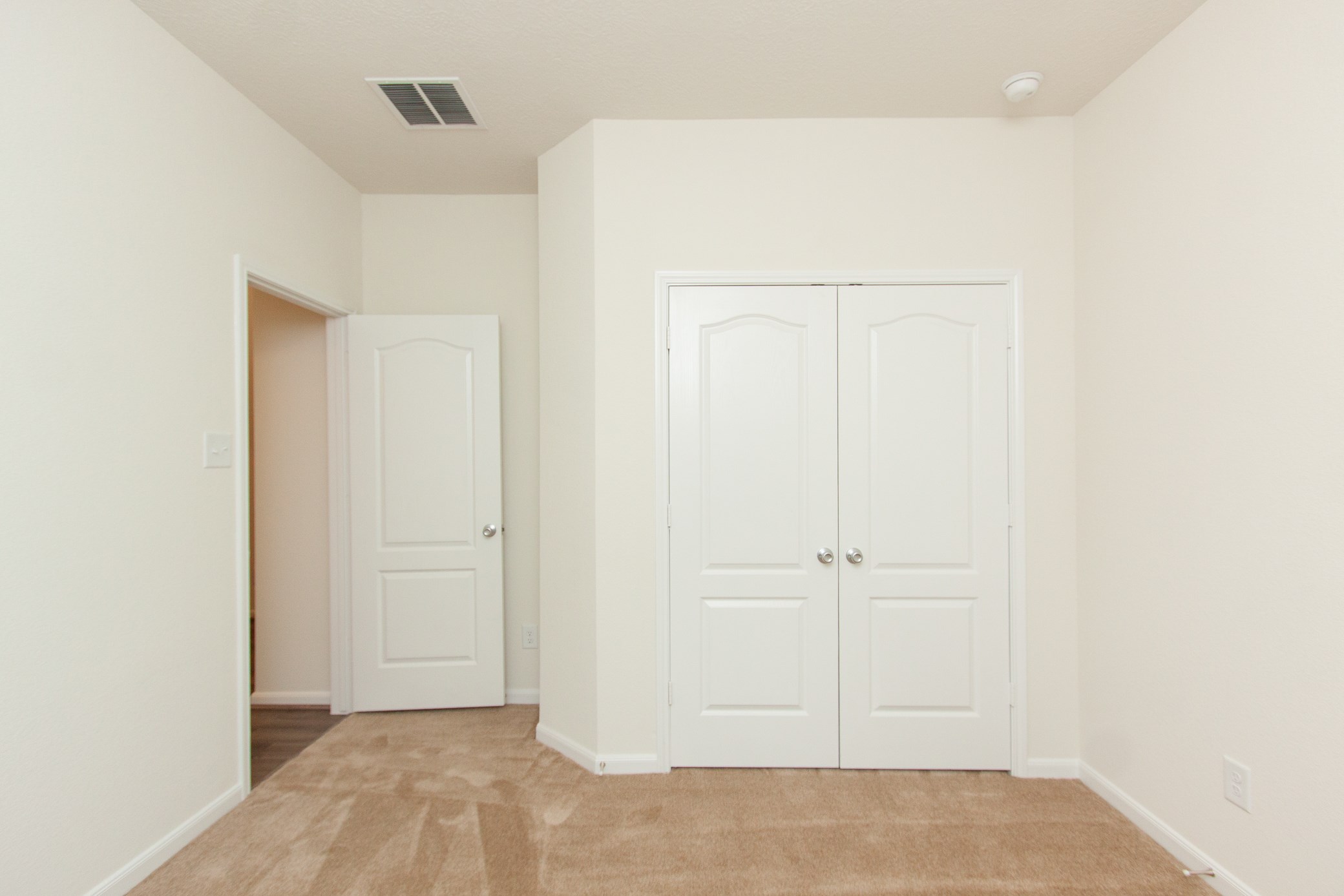 2011 Parnevik Place Conroe, TX 77304 - Photo 9 of 37 This is the view of bedroom #3. 12X11FT. This room has carpet floors and double doors to the closet.