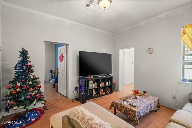 a bedroom with a bed and a table in it with window