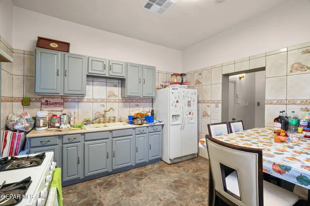 a view of a dining room with furniture and a kitchen
