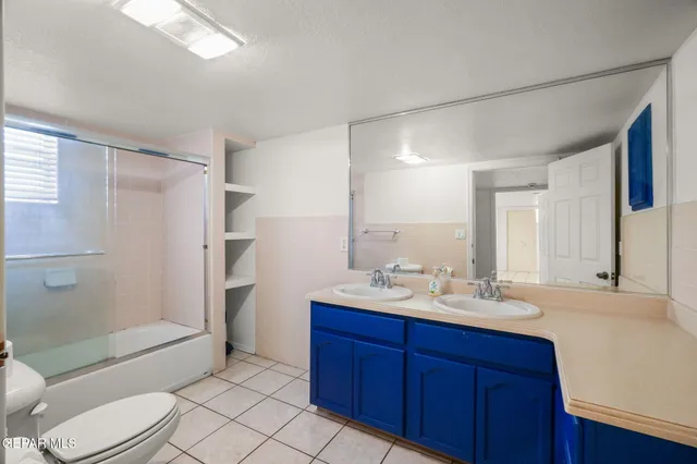 a front view of a house with a garden and parking