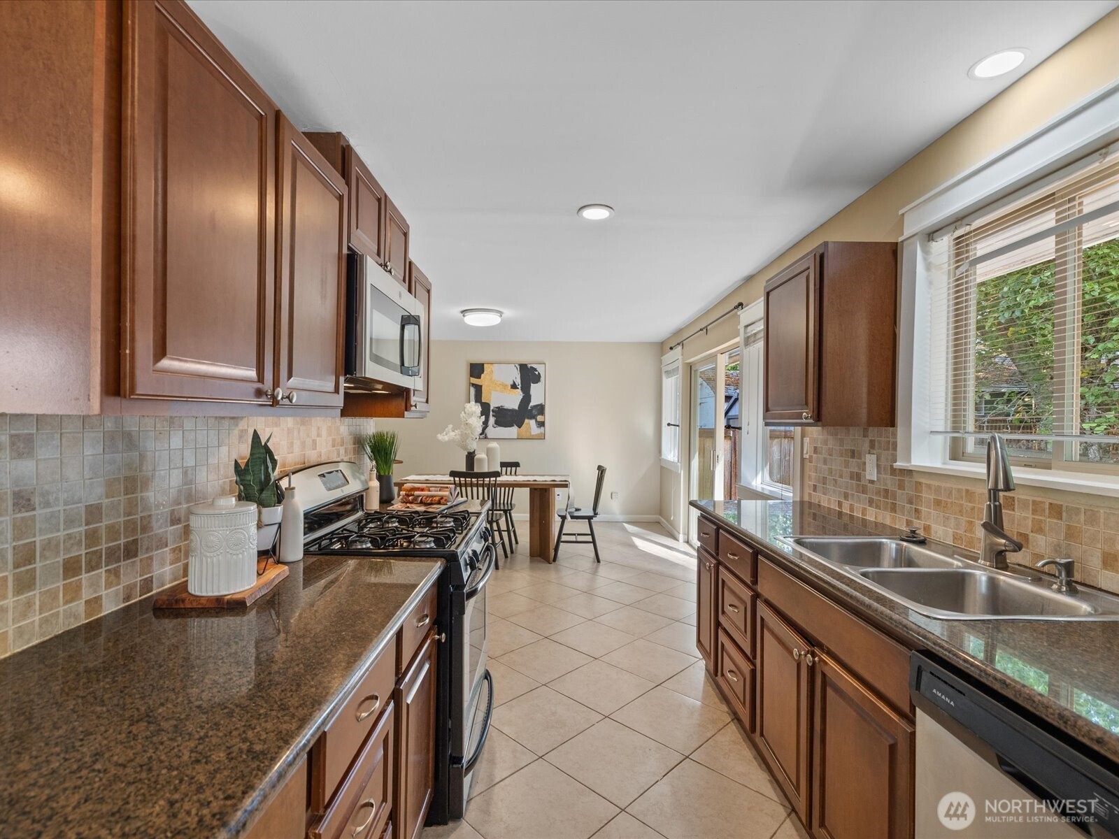 19116 106th Avenue Northeast Bothell, WA 98011 - Photo 12 of 40 a kitchen with stainless steel appliances granite countertop a sink stove and cabinets