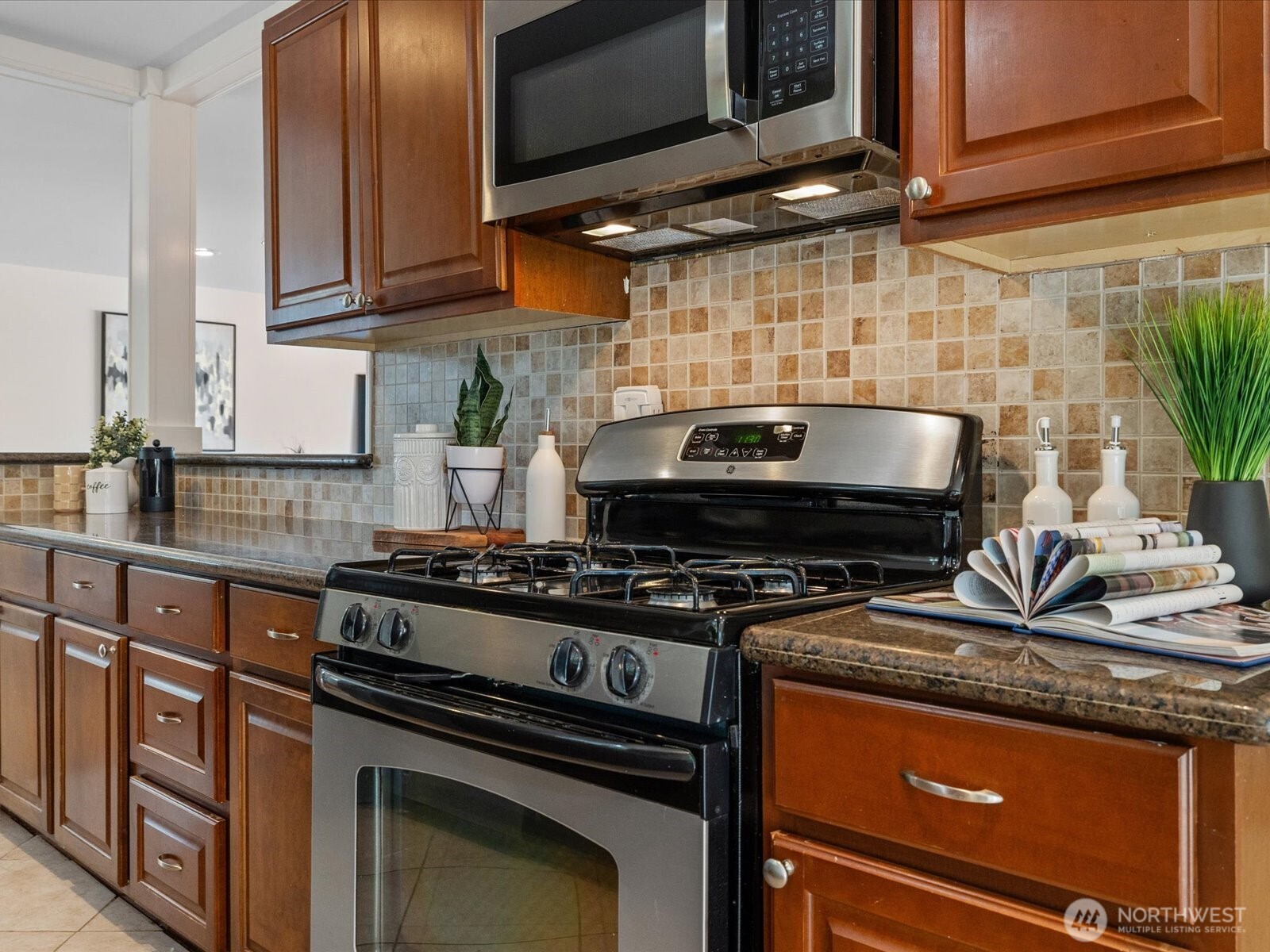 19116 106th Avenue Northeast Bothell, WA 98011 - Photo 15 of 40 a stove top oven sitting inside of a kitchen