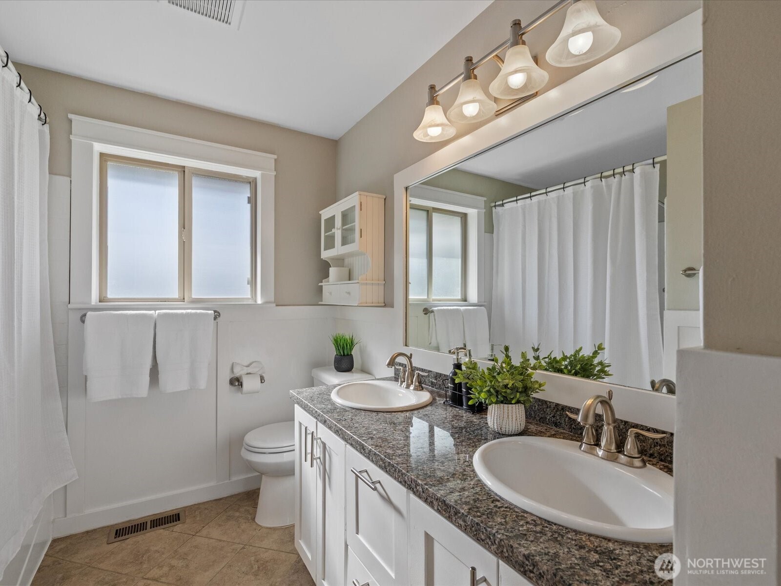 19116 106th Avenue Northeast Bothell, WA 98011 - Photo 23 of 40 a bathroom with a granite countertop double vanity sink and a mirror