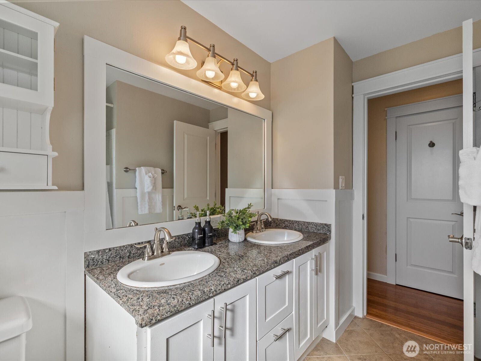 19116 106th Avenue Northeast Bothell, WA 98011 - Photo 24 of 40 a bathroom with a granite countertop sink a toilet and a mirror