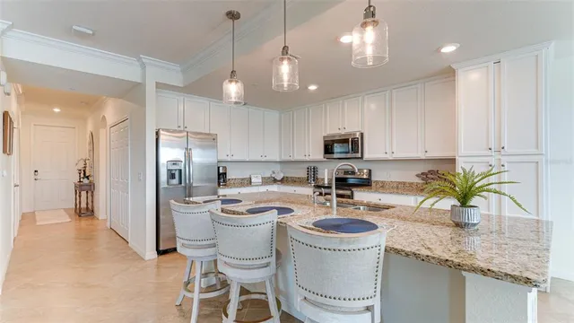 a kitchen with a refrigerator a sink and cabinets