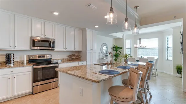a kitchen with a stove a sink a dining table and chairs