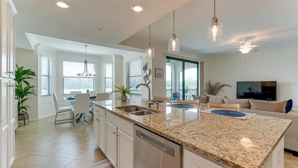 a kitchen with granite countertop lots of counter top space and living room
