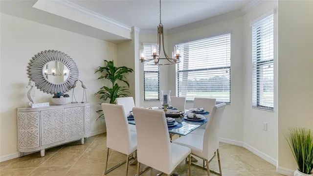 a view of a dining room with furniture wooden floor and a chandelier