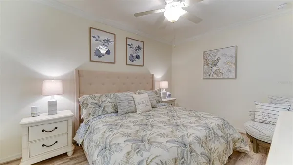 a bedroom with a bed and a lamp on dresser